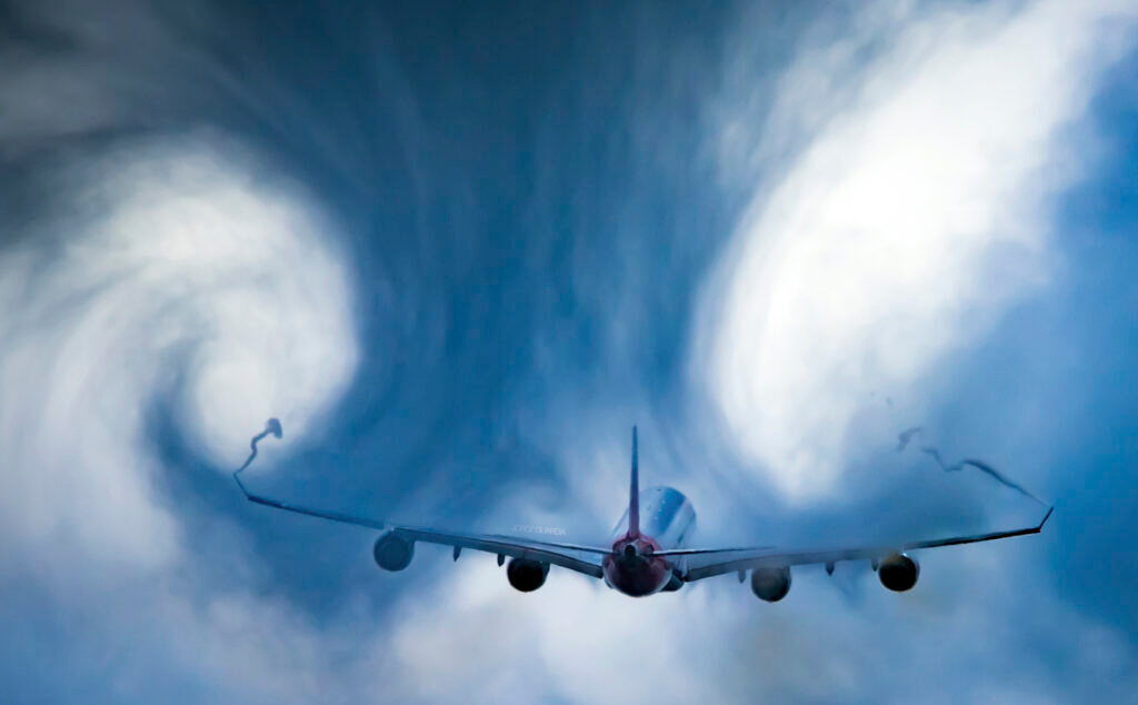 Iberia Airbus A340-600 taking off from Madrid Airport crossing a cloud and creating turbulence shapes
