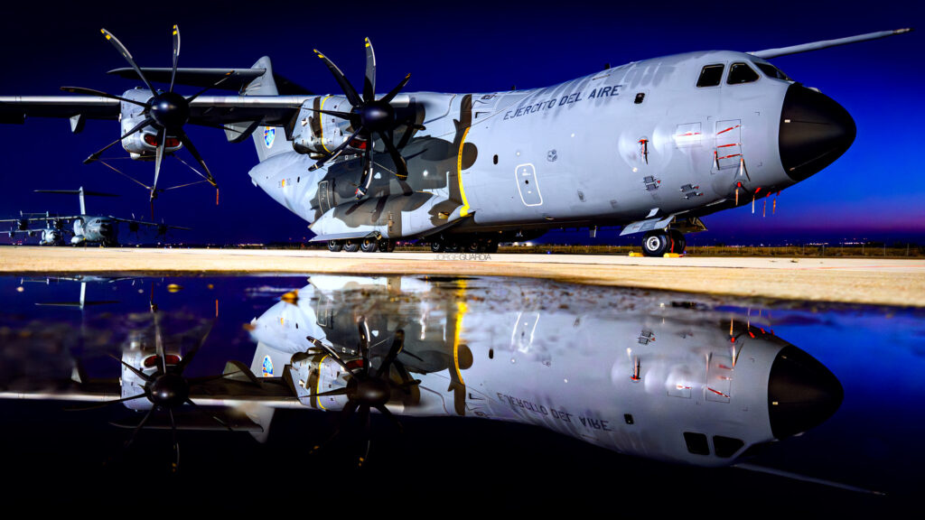 Three Airbus A400M from the Spanish Air Force at sunset with a water reflection at Zaragoza