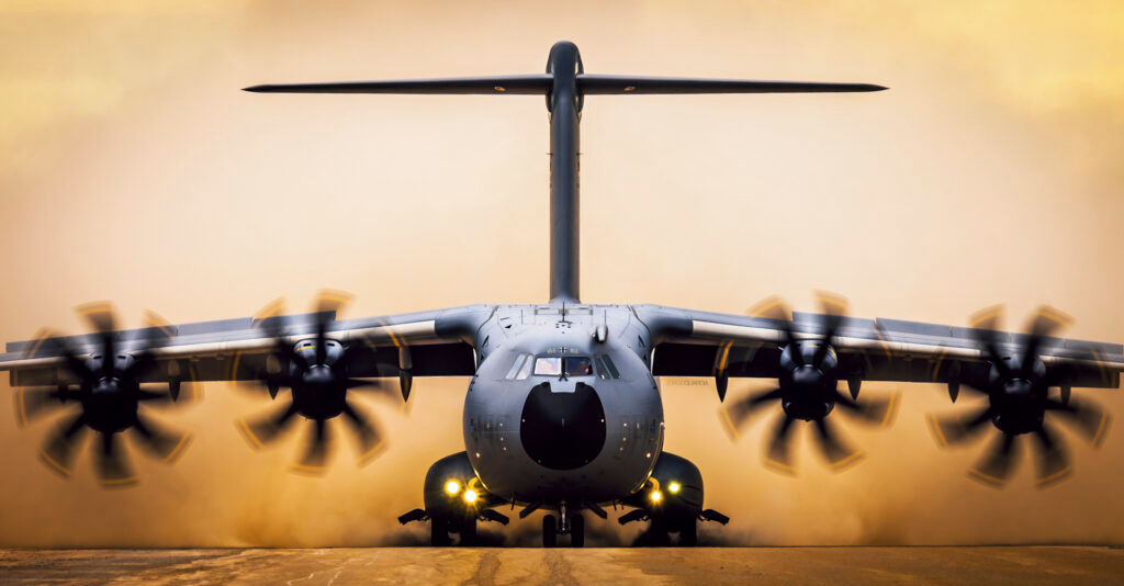 Luftwaffe Airbus A400M landing on an unpaved runway at Spain seen from the front
