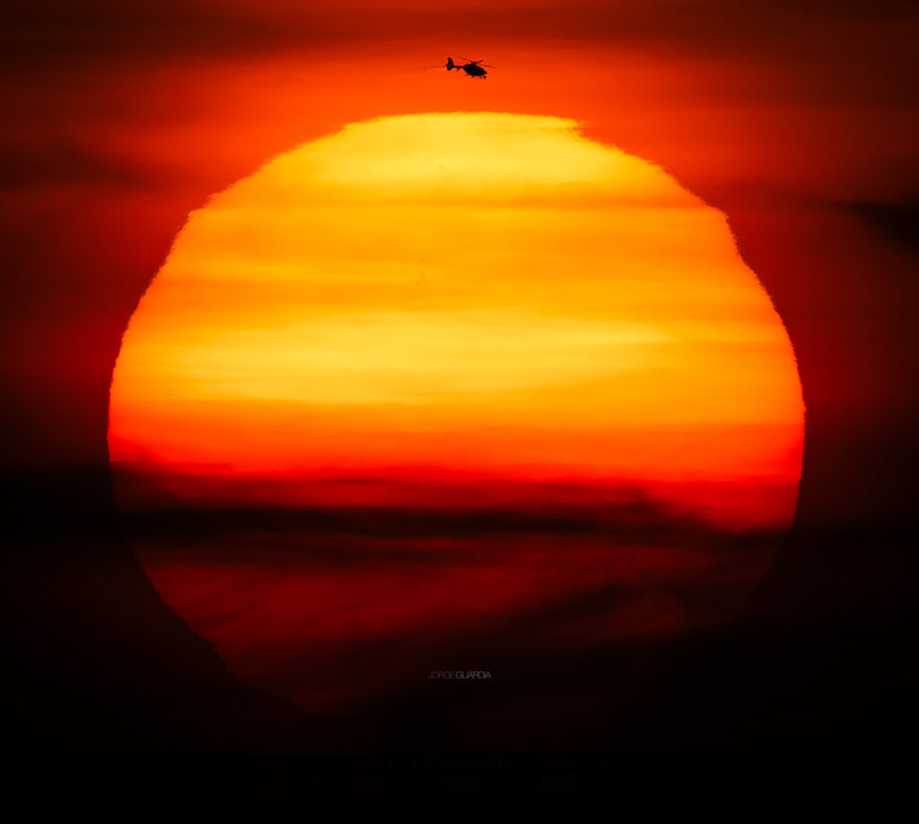 Airbus Helicopters EC135 flying above the sun at Madrid