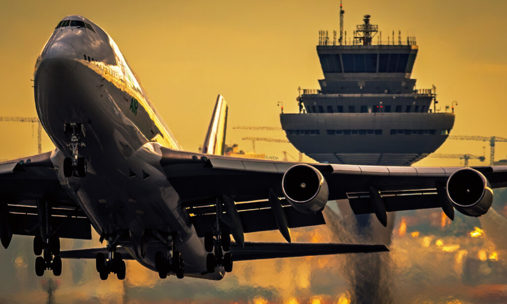 Wamos Air Boeing B747 taking off at sunset from Madrid Barajas with the Terminal 4S Control Tower in the background