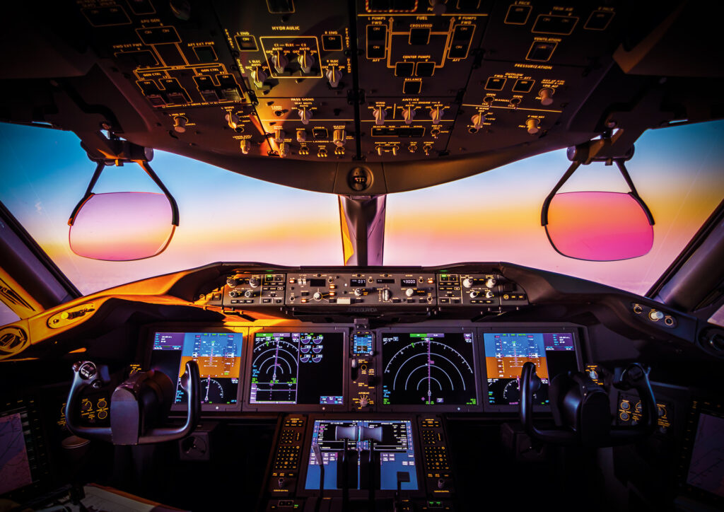 Boeing B-787 cockpit in flight during sunset over the Atlantic Ocean