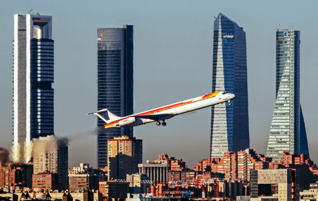Iberia Mcdonell Douglas MD88 taking off from Madrid Barajas with the Cuatro Torres Business Area in the background